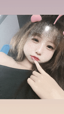 a girl with a mask on her face is taking a picture