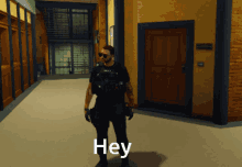 a man in a video game is standing in a hallway and says hey