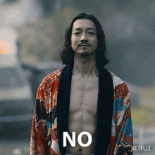 a shirtless man is standing in front of a sign that says " no "