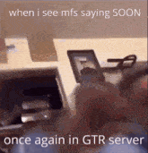 a gif of a person holding a picture that says when i see mfs saying soon