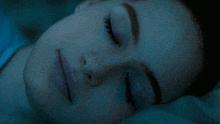 a close up of a woman 's face in a dark room