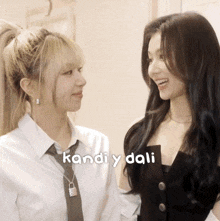 two girls are standing next to each other and the words kandi y dali are visible
