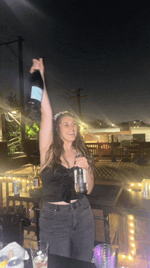 a woman holding a bottle of champagne in her hand