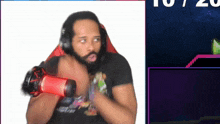 a man with a beard is wearing headphones and holding a red microphone in front of a screen that says 10/20