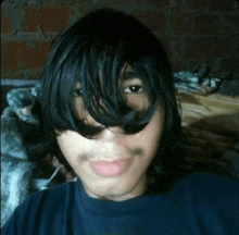 a young man with long black hair and a mustache is taking a selfie
