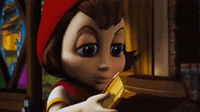little red riding hood is holding a book in her hands .
