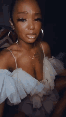 a woman wearing a white off the shoulder top with ruffles