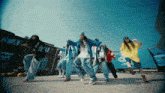 a group of people are dancing in front of a building that has a sign that says sa