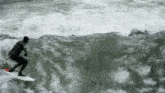 a man is riding a wave on a surfboard in the water