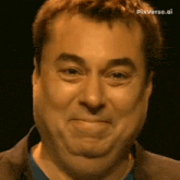 a close up of a man 's face with a funny face .