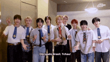 a group of young men are posing for a photo and one of them says obrigado brasil