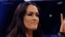 a couple of women are standing next to each other in a wrestling ring .
