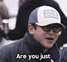 a man wearing a baseball cap and glasses is asking if he is just .