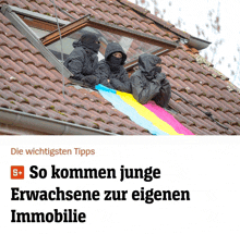 a group of people are sitting on a roof with a rainbow flag