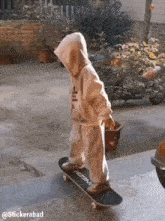 a little boy wearing a hoodie is riding a skateboard down a set of stairs .