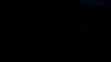 a person in a dark room with their arms outstretched reaching for something
