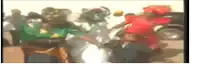 a blurry picture of a group of people standing next to each other on a street .