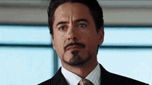 robert downey jr. is wearing a suit and tie and has a beard .