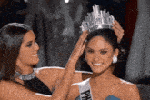 a woman wearing a miss philippines sash is being crowned by another woman