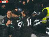 a group of soccer players are hugging each other and salah is wearing number 11