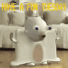 a cartoon dog is standing next to a couch with the words `` have a fun tuesday '' written above it .