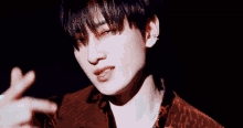 a young man with a piercing in his ear is making a funny face
