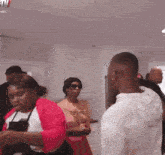 a group of people are gathered in a room with a sign that says wow on it