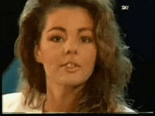 a close up of a woman 's face with her mouth open .
