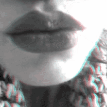 a close up of a woman 's lips with a sweater behind her