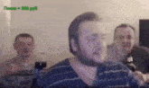 a man with a beard is sitting in front of a group of men drinking beer .