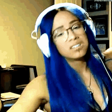 a woman with blue hair and glasses wearing white headphones
