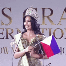 a woman wearing a crown and a sash with the word sora on it