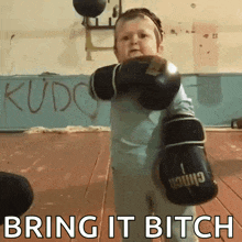 a little boy wearing boxing gloves with the words bring it bitch written on the bottom