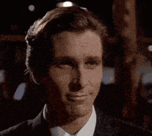 a man in a suit and tie is smiling .