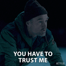 a man wearing a beanie and a jacket says you have to trust me