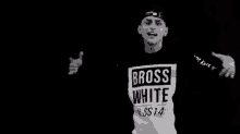 a man wearing a shirt that says " bross white "