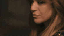 a close up of a woman 's face with brown hair