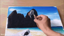 a person is painting a picture of a beach and mountains with wow art written on the bottom