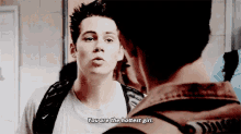 a man with a backpack is talking to another man and says you are the hottest girl