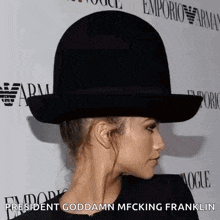 a woman wearing a black hat with the words president goddamn mfcking franklin on the bottom