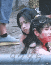 a man and a woman with blood on their faces and the number 9285 behind them