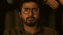 a man wearing glasses covering his mouth with his hand and the words mr romantic above him