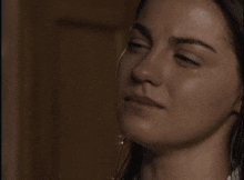 a close up of a woman 's face in a dark room