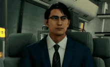 a man in a suit and tie is sitting in a chair on a bus .