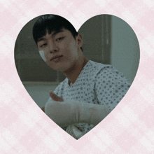 a man in a hospital gown has a bandaged arm