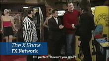 a group of people are standing in front of an arcade machine with the x show fx network written on the bottom