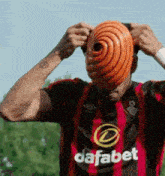 a man wearing a red and black jersey with dafabet on it