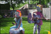 a girl playing a guitar next to a girl sitting on a cooler in a backyard