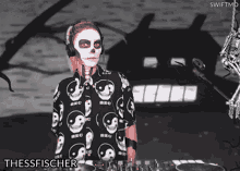 a woman wearing headphones and a shirt with skulls on it is called thesesfischer