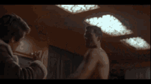 a shirtless man with green hair is standing in front of a window